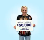 Winner Gary holds a check for $50,000 in his hands